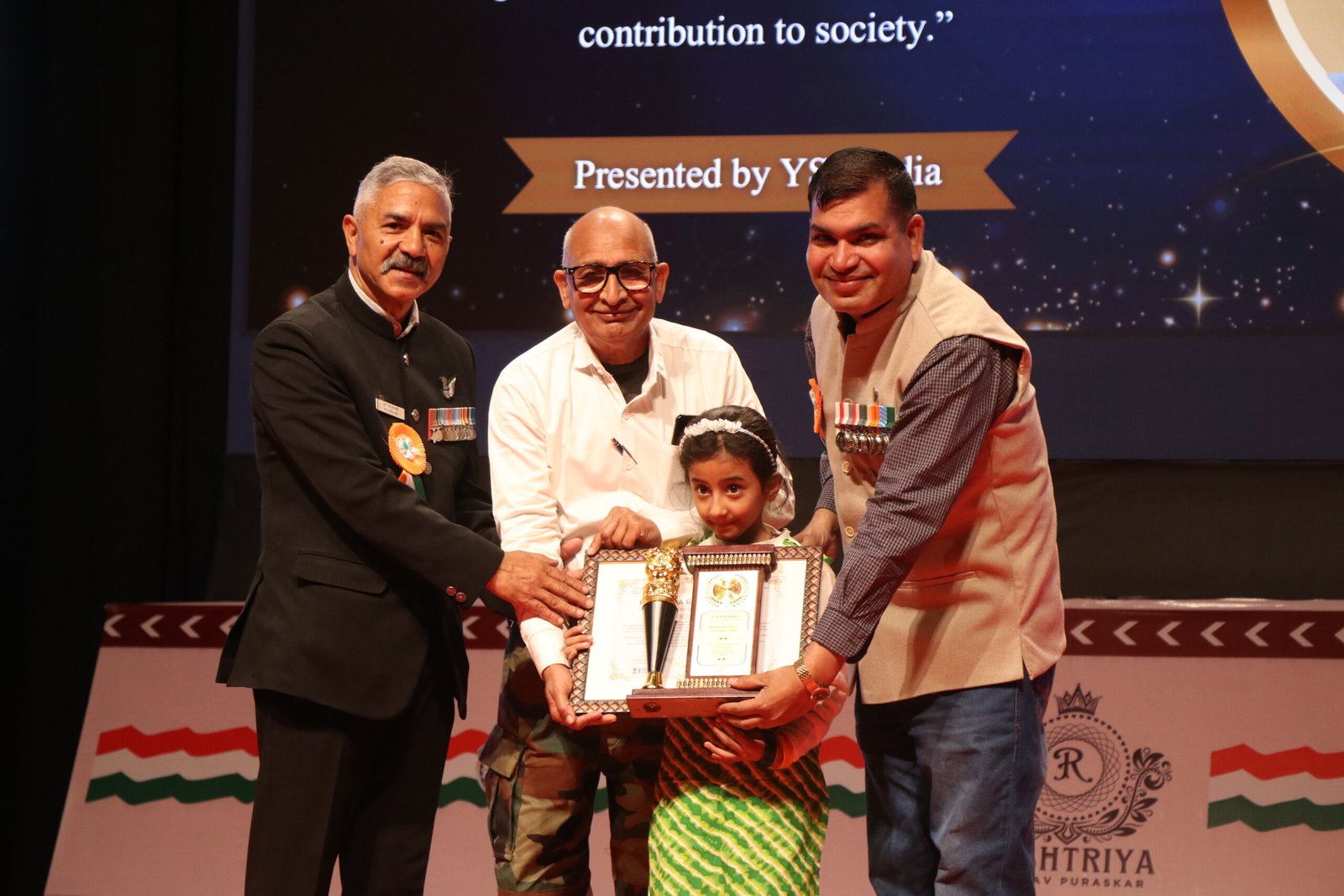 A young award recipient being honoured on stage